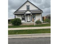 Charming home with a well-manicured lawn, inviting front porch and beautiful curb appeal at 2874 Rose Hill St, Strasburg, CO 80136