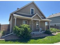 Charming single Gathering home features a cozy front porch and well-maintained landscaping at 2874 Rose Hill St, Strasburg, CO 80136