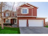 Charming two-story home with a well-maintained lawn and a spacious two car garage at 2954 E 108Th Dr, Northglenn, CO 80233