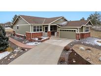 Charming single-story home with a well-maintained lawn and inviting brick accents at 23312 E Chestnut Pl, Aurora, CO 80016