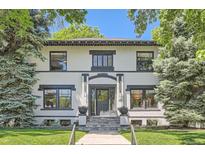 Charming home with black trim, stone stairs, and lush landscaping at 785 Fillmore St, Denver, CO 80206