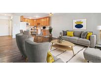 Bright, open-concept living space featuring hardwood floors and contemporary furnishings at 775 S Alton Way # 3C, Denver, CO 80247