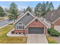 Charming home featuring mixed siding, brick accents, and a two-car garage at 2295 S Depew St, Denver, CO 80227