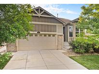 Charming home featuring a two-car garage, brick accents, and well-maintained landscaping at 5613 S Elk Ct, Aurora, CO 80016