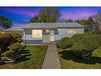 Charming single-story home with a landscaped front yard and inviting walkway at 1211 S Zuni St, Denver, CO 80223
