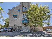 Attractive brick building with mature landscaping and welcoming entrance at The Lofts at Byers School at 108 W Byers Pl # G1, Denver, CO 80223