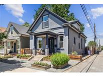 Charming gray two-story home with landscaped front yard and inviting porch at 1519 E 29Th Ave, Denver, CO 80205