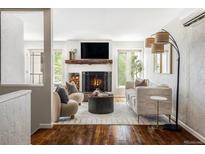 Inviting living room with a cozy fireplace, hardwood floors, and stylish contemporary furnishings at 377 Pearl St # 5, Boulder, CO 80302