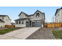 Charming two-story home with a gray exterior, well-maintained landscaping, and a spacious driveway at 154 Cortona Pl, Castle Pines, CO 80108
