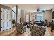 A cozy living room features stylish seating, a ceiling fan, and natural light streaming through the window at 2256 S Dexter St, Denver, CO 80222