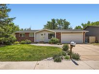 Charming home with brick accents, well-maintained lawn, and attached two-car garage at 9146 W 89Th Ct, Broomfield, CO 80021