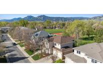 Two-story home with a landscaped yard, set against a backdrop of scenic mountain views at 4059 Nevis St, Boulder, CO 80301