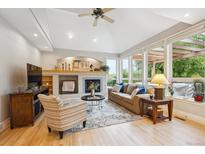 Cozy living room with fireplace, high ceilings, and bright natural light at 4059 Nevis St, Boulder, CO 80301