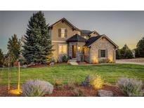 Two-story house with stone accents and landscaping at 5268 Talavero Pl, Parker, CO 80134