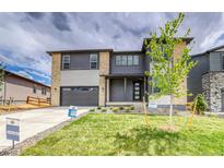 Beautiful two-story home featuring a landscaped front yard and a two-car garage at 23708 E 42Nd Ave, Aurora, CO 80019