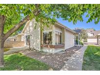 Charming single-story home with a well-maintained lawn and a peaceful, tree-shaded setting at 2288 S Depew St, Lakewood, CO 80227