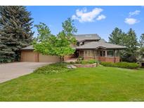 Charming home with lush landscaping, mature trees, and a welcoming front yard, perfect for suburban living at 9 Red Fox Ln, Littleton, CO 80127