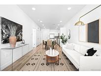 Spacious living room with a large rug, contemporary decor, and lots of natural light throughout the home at 2851 W 52Nd Ave # 304, Denver, CO 80221