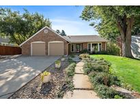 Charming brick home featuring a two-car garage and inviting front yard landscaping at 7583 S Xanthia Ct, Centennial, CO 80112
