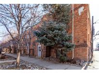 Brick apartment building featuring a sidewalk and rock landscaping at 1024 E 14Th Ave # 10, Denver, CO 80218