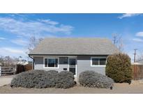 Charming single story house featuring light gray siding and well-maintained landscaping at 3095 W Harvard Ave, Denver, CO 80219