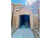 Welcoming stone entrance with a staircase, creating an inviting first impression of the property at 7440 S Blackhawk St # 207, Englewood, CO 80112