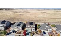 Aerial view of a charming neighborhood with houses featuring solar panels at 3158 S Nepal Way, Aurora, CO 80013