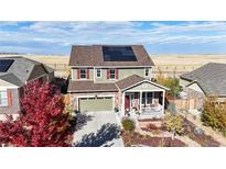 Aerial view of two story house with solar panels and landscaped yard at 3158 S Nepal Way, Aurora, CO 80013