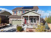 Two-story house with solar panels, attached garage, and landscaping at 3158 S Nepal Way, Aurora, CO 80013