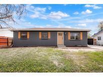 Charming single-story home featuring a stylish brick exterior with complementary wood shutters at 13202 Olmsted Pl, Denver, CO 80239