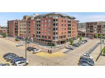 Brick apartment building with balconies above a parking lot, perfect for city living at 2229 Blake St # 505, Denver, CO 80205