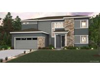 Two story home featuring stone accents, gray siding, a two car garage, and a manicured lawn at 2489 Lupton Ln, Lafayette, CO 80026