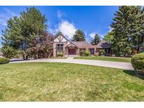 Charming two-story home with well-manicured lawn, mature trees and circular driveway at 5365 W Princeton Dr, Denver, CO 80235
