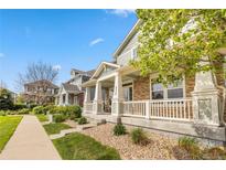 Inviting home boasts a charming front porch with classic white railings and sturdy column supports at 9530 Gray St, Westminster, CO 80031