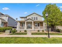 Inviting two-story home with a charming front porch, manicured lawn, and fresh landscaping at 9530 Gray St, Westminster, CO 80031