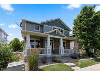 Charming two-story home featuring a welcoming front porch and professionally landscaped front yard at 9530 Gray St, Westminster, CO 80031