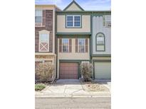 Charming townhome featuring a one-car garage and neutral exterior at 12031 E Ford Cir, Aurora, CO 80012