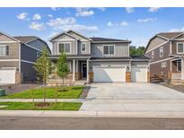 Beautiful two-story home with a three car garage, stone accents and landscaped front yard at 13465 Valentia Pl, Thornton, CO 80602