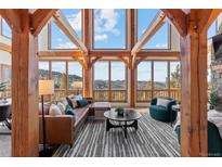 Spacious living room boasts stunning mountain views & high ceilings at 13326 Kuehster Rd, Littleton, CO 80127