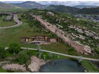Stunning modern home with a pool nestled against a dramatic rock formation and mountain views at 15175 W Belleview Ave, Morrison, CO 80465