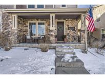 Charming home with a stone front porch and a welcoming wreath on the front door at 10246 Tall Oaks Cir, Parker, CO 80134