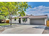 Charming single-story home featuring a well-maintained lawn and a two-car attached garage at 1226 W 98Th Ave, Northglenn, CO 80260