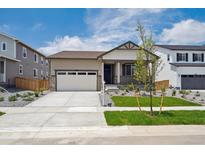 Charming single-story home with a two-car garage and well-manicured lawn at 2668 Simpson Ln, Erie, CO 80026