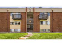 Brick apartment building featuring inviting balconies and well-maintained landscaping at 3653 S Sheridan Blvd # 16, Denver, CO 80235
