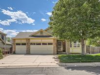 Charming single-Gathering home with a three-car garage and mature landscaping in a peaceful neighborhood at 1649 Iris St, Broomfield, CO 80020