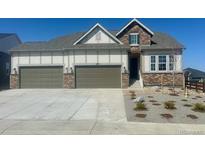 Charming two-story home featuring a three-car garage and manicured landscaping at 3867 Freestone Pt, Castle Rock, CO 80108