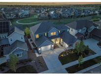 A beautiful two-story home with an attached garage and manicured landscaping at 8179 S Kellerman Cir, Aurora, CO 80016