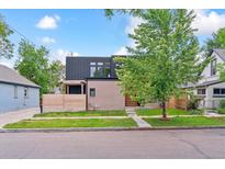 Modern two-story home with brick facade, black metal roof, and a well-manicured front lawn at 2280 W 42Nd Ave, Denver, CO 80211