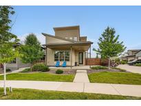 Contemporary two-story home featuring a well-manicured front yard, a covered porch, and stylish architectural details at 9636 Bennett Peak St, Littleton, CO 80125