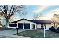 Charming single-story home featuring a two-car garage and inviting front yard at 2538 S Dover Way, Lakewood, CO 80227